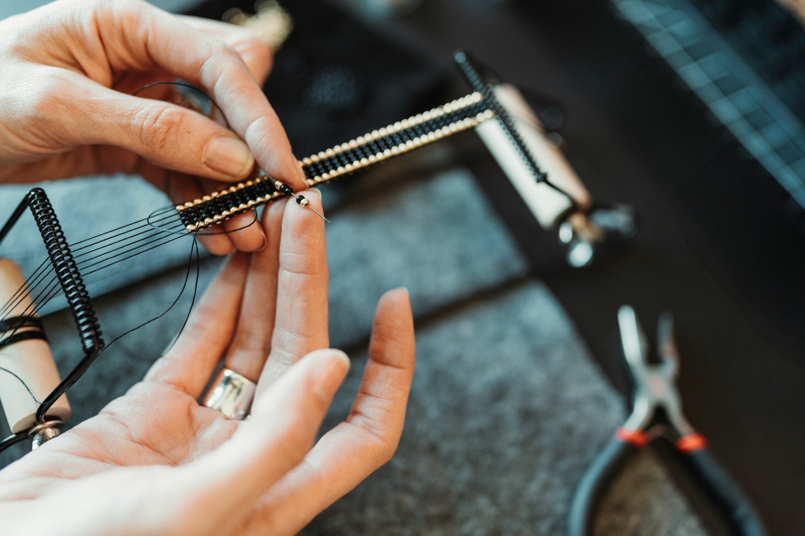 a person is working on a piece of jewelry